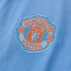 Escudo de la chaqueta del chándal celeste del Manchester United 2022-2023