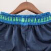 pantalon corto timberwolves celeste cintura con diseño de arboles verdes