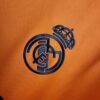 camiseta real madrid naranja escudo