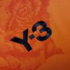 camiseta real madrid naranja logo