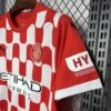 camiseta-girona-primera-equipacion-2024-2025-puño-izquierdo