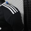 camiseta-real-madrid-version-jugador-portero-negro-2024-2025-puño-izquierdo
