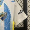 Conjunto Niño Málaga Primera Equipacion 2024-2025 puño