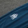 Chandal Olympique Masella Celeste 2024-2025 escudo pantalon