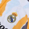 Chandal Real Madrid amarillo 2024-2025 escudo