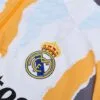 Chandal Real Madrid amarillo 2024-2025 escudo