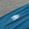 Chandal Marsella Celeste 2024-2025 escudo
