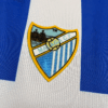camiseta-malaga-primera-equipacion-2025-2026-escudo