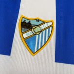 camiseta-malaga-primera-equipacion-2025-2026-escudo
