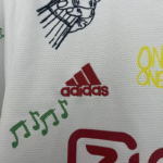 Camiseta Ajax 2025-2026 Edición Especial Bob Marley 40 Aniversario-escudo