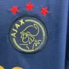 camiseta-ajax-bob-marley-edicion-especial-azul-2025-2026-escudo