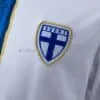 camiseta-filandia-primera-equipacion-2026-escudo
