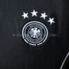 camiseta-alemania-polo-negro-2025-2026-escudo